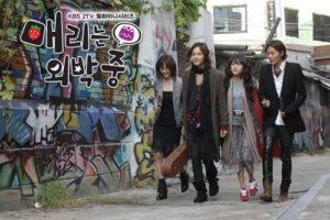 Four friends walking past graffiti-covered wall