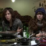 Two people at restaurant table with hot pot