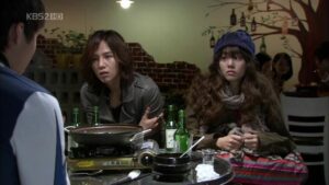 Two people at restaurant table with hot pot