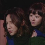 Two women outdoors at night, piggyback ride