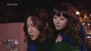 Two women outdoors at night, piggyback ride