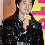 Man in black jacket speaking into microphone