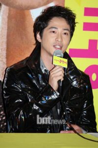 Man in black jacket speaking into microphone