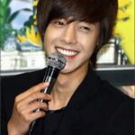 Smiling man holding microphone