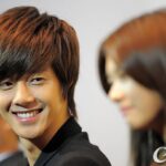Smiling young man looking at blurred woman