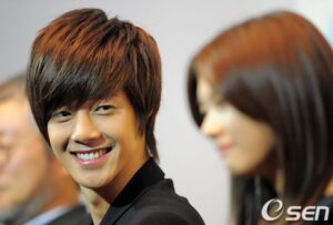 Smiling young man looking at blurred woman