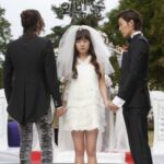 Bride between two men at outdoor wedding