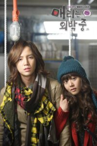 Two people in winter clothes on swing