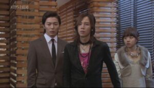 Three surprised people in stylish clothing indoors
