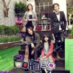 Four people posing on garden steps