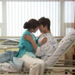 Young couple embracing on hospital bed