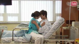 Young couple embracing on hospital bed