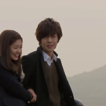 Young couple smiling outdoors at sunset