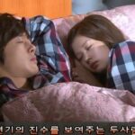 Two people sleeping in bed