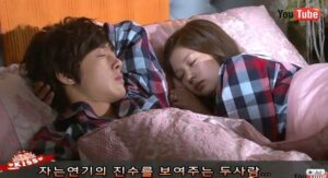 Two people sleeping in bed