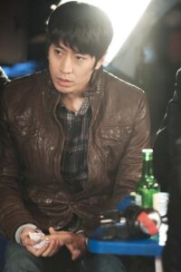 man in brown leather jacket holding tissue