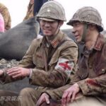 Two soldiers in vintage uniforms, medic armband