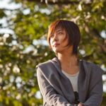 Woman gazing upward while sitting outdoors