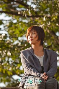 Woman gazing upward while sitting outdoors