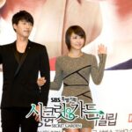 Two people waving at promotional press event
