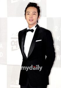 Man in black tuxedo smiling at event