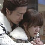 Man comforting crying woman in embrace