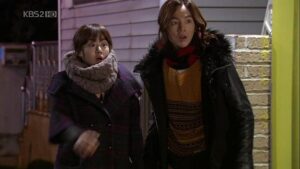 Two surprised people in winter coats outdoors
