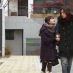 Young couple walking on urban sidewalk in winter