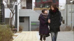 Young couple walking on urban sidewalk in winter