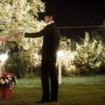 Couple holding hands in twinkling garden