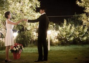 Couple holding hands in twinkling garden