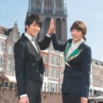 Two smiling professionals high-fiving by canal