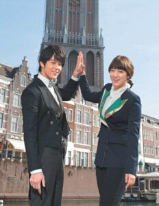 Two smiling professionals high-fiving by canal