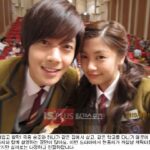 Two smiling students in school uniforms taking selfie