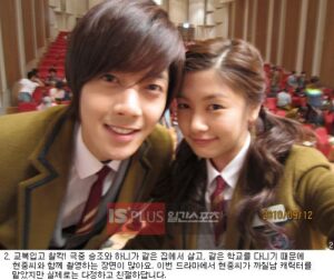 Two smiling students in school uniforms taking selfie