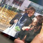 Hands holding photo of two smiling people