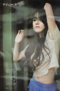 Young woman behind glass, raising her arm