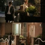 Two people outside brick house in rain