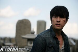 Man with cheek cut looking aside among tombstones