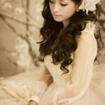Woman in cream vintage dress with flower