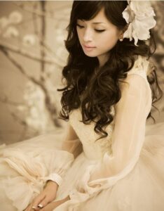 Woman in cream vintage dress with flower