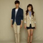 Two young people standing in blazers