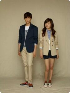 Two young people standing in blazers