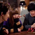 Three young friends chatting at living room table