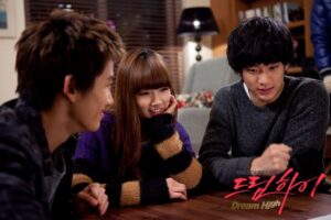 Three young friends chatting at living room table