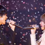 Two singers duet amid falling confetti