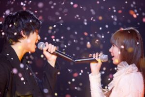 Two singers duet amid falling confetti