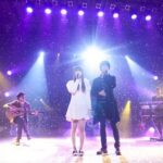 Duet singers performing on lit stage with confetti