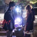 Man and woman talking outside at night