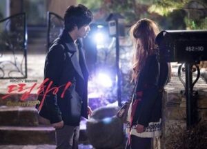 Man and woman talking outside at night